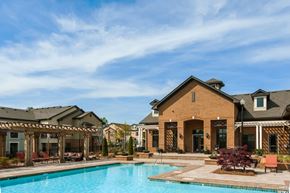 Greenville apartment for rent - A large house with a pool in front.