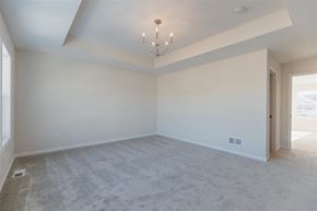 Blaine house for rent - A spacious room with a carpeted floor and a chandelier hanging from the ceiling.