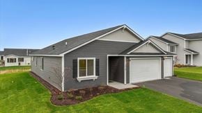 New Richmond house for rent - A grey house with a white garage door and a window.