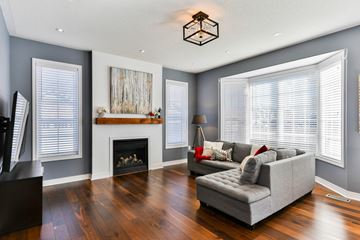 Raleigh apartment for rent - A living room with a grey couch and a fireplace.