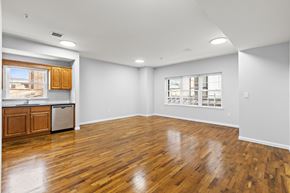 Newark apartment for rent - A large empty room with wooden floors and white walls.