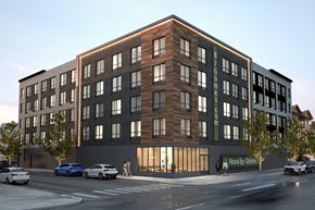 Newark apartment for rent - A modern building with a green sign on the side.