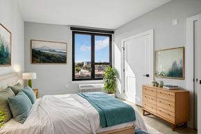 Newark apartment for rent - a bedroom with a bed and a large window
