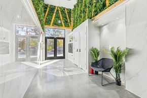 Newark apartment for rent - a lobby with a plant wall on the ceiling and a door