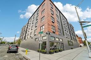 Newark apartment for rent - A street view of a building with a car parked in front.