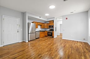 Newark apartment for rent - A kitchen with wooden floors and white walls.