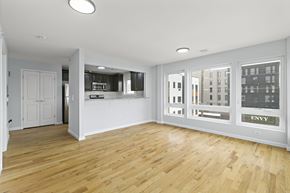 Newark apartment for rent - A spacious room with wooden floors and white walls.