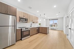 Newark apartment for rent - A modern kitchen with wooden cabinets and stainless steel appliances.