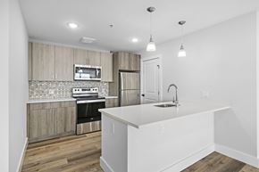 Newark apartment for rent - A kitchen with a white countertop and wooden cabinets.