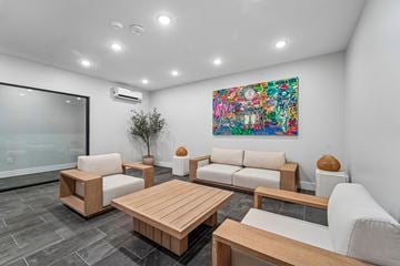 Newark apartment for rent - A modern living room with a large painting on the wall and comfortable seating.