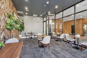 Newark apartment for rent - A modern dining area with wooden tables and chairs.