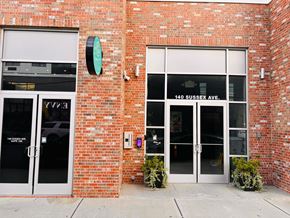 Newark apartment for rent - The front of a building with a brick wall and glass doors.
