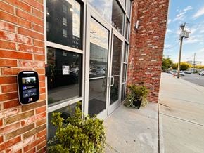 Newark apartment for rent - A brick building with a glass door and a parking meter on the sidewalk.