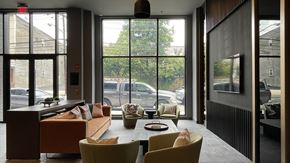 Newark apartment for rent - A modern living room with a couch, chairs, and a coffee table.