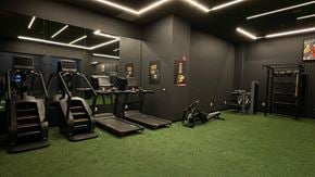 Newark apartment for rent - a gym with treadmills and weights on a green floor