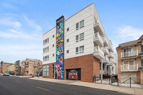 Newark apartment for rent - A white building with a colorful mural on the side.
