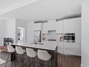 Calgary apartment for rent - a kitchen with white cabinets and a marble counter top