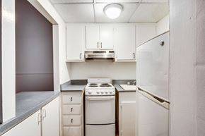 Baltimore apartment for rent - a white kitchen with white appliances and white cabinets