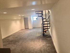 Baltimore apartment for rent - a small basement with a spiral staircase in the middle of it