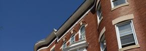 Baltimore apartment for rent - the side of a brick building with windows and a roof