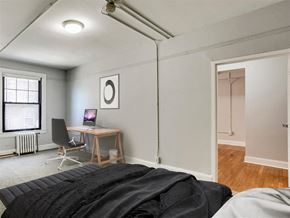Baltimore apartment for rent - a bedroom with a bed and a desk with a computer