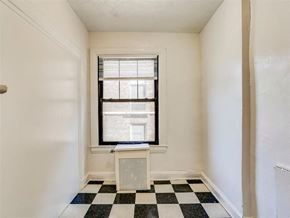 Baltimore apartment for rent - a room with a window and a checkered floor