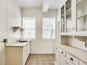Baltimore apartment for rent - a kitchen with white cabinets and a sink and a window