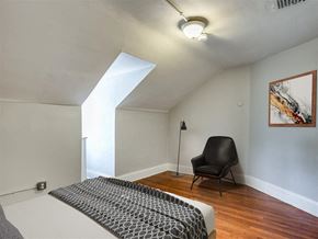 Baltimore apartment for rent - a bedroom with a bed and a chair in the corner