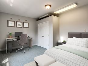 Baltimore apartment for rent - A bedroom with a bed, desk, and chair.