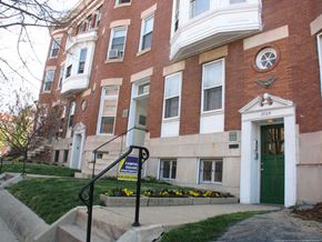 Baltimore apartment for rent - a red brick building with a green door and stairs