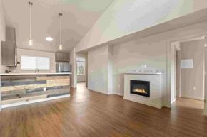 Post Falls apartment for rent - an empty living room with a fireplace and a kitchen
