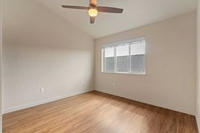 Post Falls apartment for rent - A room with a ceiling fan and a window with blinds.