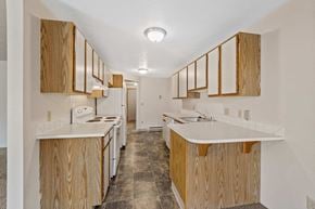 Spokane apartment for rent - a kitchen with wood cabinets and white counter tops