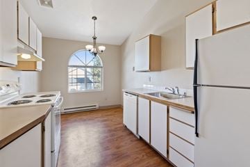 Spokane apartment for rent - an empty kitchen with white appliances and a window