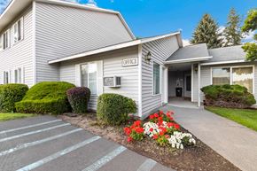 Spokane Valley apartment for rent - A grey building with a sign that says leasing office