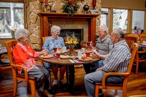 Coeur D'alene apartment for rent - a group of people sitting around a table eating food
