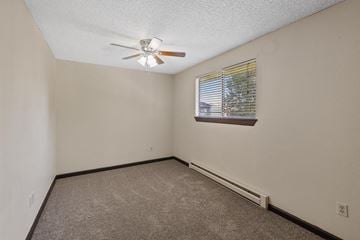 Spokane apartment for rent - the living room of a home with a ceiling fan and a window