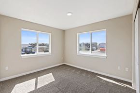 Airway Heights apartment for rent - an empty bedroom with two windows and a carpeted floor