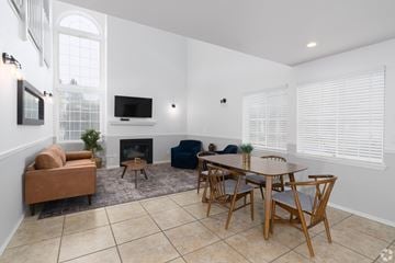 Spokane apartment for rent - a living room with a table and chairs and a fireplace