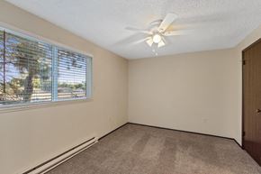 Spokane apartment for rent - A room with a window and a ceiling fan.