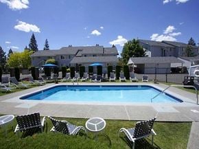Spokane apartment for rent - a swimming pool with chairs and chairs around it
