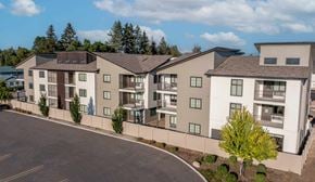 Post Falls apartment for rent - an exterior view of an apartment building with a road in front of it
