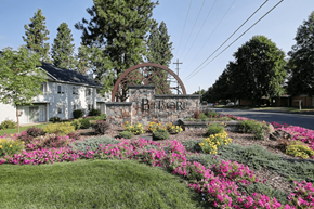 Spokane apartment for rent - a sign that reads Biltmore Apartments in front of a garden with flowers