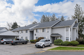 Spokane apartment for rent - the view of an apartment building with cars parked in front of it