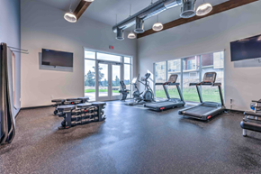 Spokane apartment for rent - A gym with treadmills, elliptical machines, and a television.