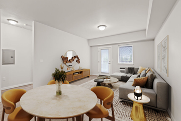 Spokane apartment for rent - A modern living room with a round table and yellow chairs.