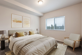 Spokane apartment for rent - A bedroom with a large bed and a chair.