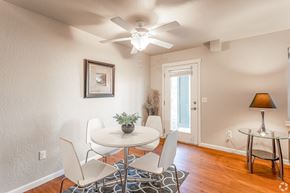 Cda apartment for rent - a dining room with a table and chairs and a ceiling fan