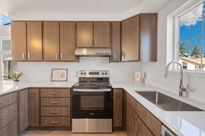 Post Falls apartment for rent - a kitchen with wooden cabinets and a stove and a sink