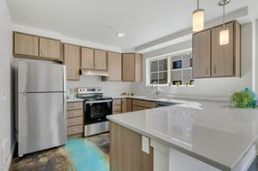 Post Falls apartment for rent - a kitchen with a large island and stainless steel appliances